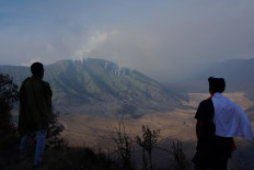 Local residents watch burning savanna at the Bromo Tengger Semeru National Park from a distance in Lumajang, East Java, on Sept. 7, 2023.  Lumajang disaster mitigation agency estimated around 611 hectares of the national park was burned by a wildfire triggered by the dry weather.
