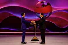 President Joko “Jokowi” Widodo (left) and Laos' Prime Minister Sonexay Siphandone shake hands on Sept. 7, 2023 during the handover of ASEAN's presidency at the closing ceremony of the 43rd ASEAN Summit in Jakarta.
