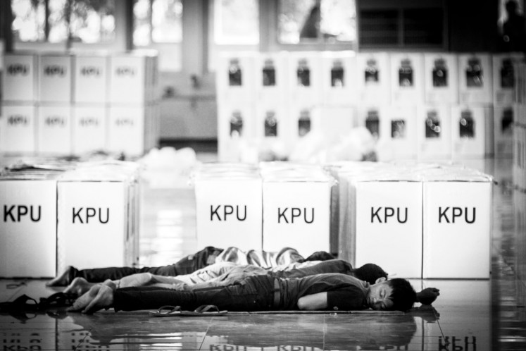 Workers who fold ballot papers and ballot card boxes for the 2019 general election sleep on the ground on April 15, 2019, at the Sriwijaya Promotion Center in Jakabaring, Palembang, South Sumatra.