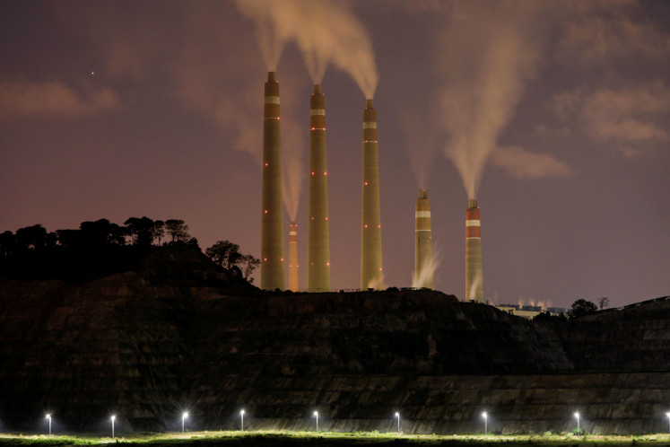 Smoke and steam billows from the coal-fired power plant owned by Indonesia Power, next to an area for Java 9 and 10 Coal-Fired Steam Power Plant Project in Suralaya, Banten, Indonesia, on July 11, 2020.