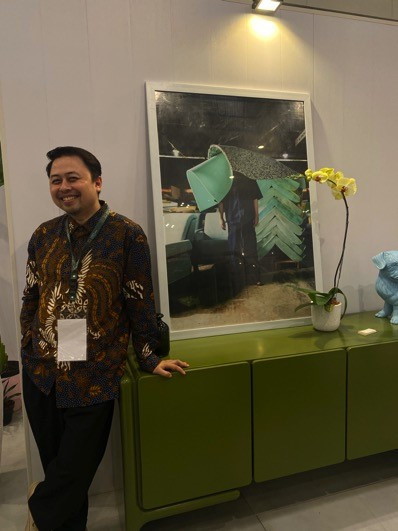 Eugenio Hendro poses with pieces from his Nostalgic Neon Pop Collection at the IFFINA furniture expo 2023 on Sept. 14.