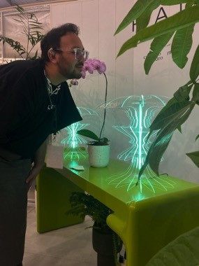 Liko Sukhoy, founder and creative director of his eponymously named design company as well as a graphic designer, looks over his first interior creation, a neon lamp named Re.Volt, on Sept. 14 at the 2023 IFFINA furniture expo.