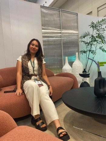 Cynthia Margareth sits on a sofa from her elegantly designed Lila Collection, a pale terracotta piece that embraces playful femininity in its non-angular lines, at the IFFINA furniture expo on Sept. 14.