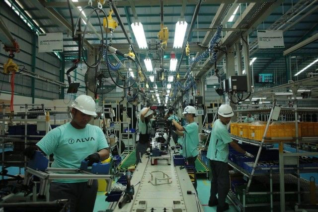 Workers assemble electric motorbikes at the Alva manufacturing facility in Cikarang, West Java, in an undated handout photograph.