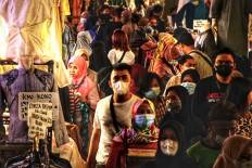 People shop at the Tanah Abang wholesale market ahead of the Idul Fitri celebrations, in Jakarta on May 3, 2021.