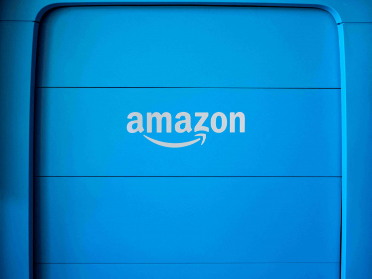 FILE PHOTO: The back hatch of an Amazon EV van powered by Rivian that is parked at the Amazon Logistics Facility in Chicago. Illinois, U.S. July 21, 2022.  REUTERS/Jim Vondruska/File Photo