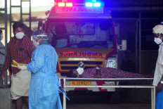 A health worker wearing protective gear moves a woman with symptoms of Nipah virus to an isolation ward on Sept. 16, 2023, at a government hospital in Kozhikode in the South Indian state of Kerala.