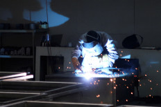 An employee works on the production line at the Jingjin filter press factory in Dezhou, Shandong province, China, on Aug. 25, 2022.