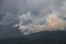 Smoke envelopes the site of wildfires on Mount Lawu in Ngawi, East Java, as witnessed from nearby Karanggubito village on Monday, Oct. 2, 2023. According to data from authorities tasked with putting out the fires, more than 400 hectares of forest cover on Lawu has been set ablaze since Sept. 29, bringing the total area of forest lost to fire to around 1,100 hectares since Aug. 30.