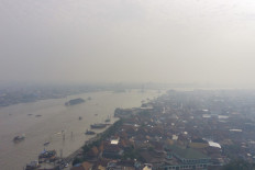 An aerial view shows the Musi river amid haze due to an ongoing wildfire in Palembang, South Sumatra on September 14, 2023.
