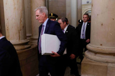 Former Speaker of the House Kevin McCarthy (center) carries a box as he leaves the office of the Speaker of the House and heads out of the US Capitol several hours after being ousted from the position of Speaker by a vote of the House of Representatives on Capitol Hill in Washington, US October 3, 2023.