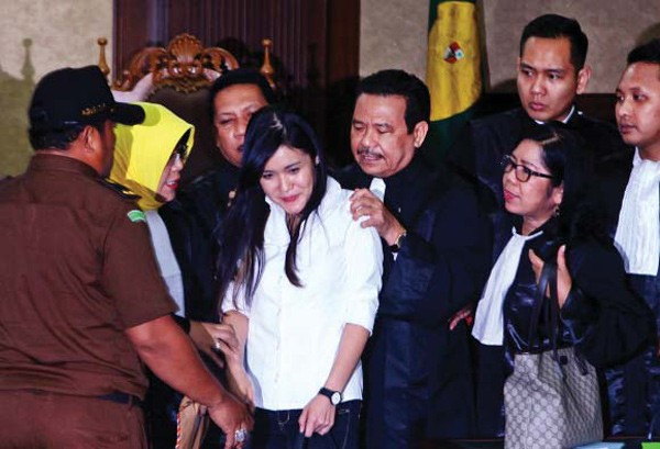 All smiles: Jessica Kumala Wongso (fourth left) smiles as her lawyers consoled her after judges found her guilty of murder at the Central Jakarta Court on Oct. 27, 2016.