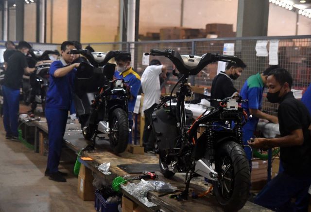 Mass rollout: Workers assemble electric motorcycles on Sept. 21, 2023, at Plant II of manufacturer PT Terang Dunia Internusa in Citeureup, Bogor, West Java.
