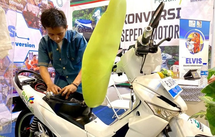 Students of the SMKN 55 state vocational school in Jakarta  exhibit on Sept. 27, 2023, motorcycles converted from internal combustion engines to electric power during the Jakarta Innovation Days event