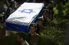 Israeli army soldiers carry the coffin with the remains of their comrade Noam Elimeleh Rothenberg during his funeral at Mount Herzel Cemetery in Jerusalem on October 10, 2023. Fighting between Israel and Hamas entered fourth day, after the Palestinian militant group launched a massive surprise assault from Gaza that precipitated mass mobilisation on both sides of the Palestinian-Israeli divide.
