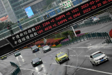An electronic board shows stock indexes at the Lujiazui financial district in Shanghai, China, March 21, 2023.