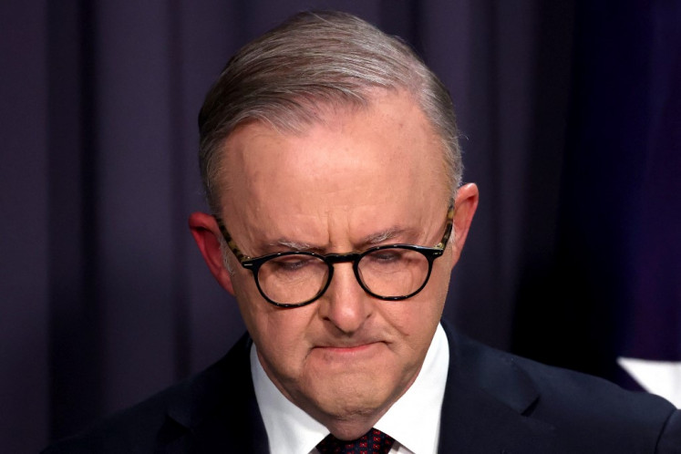 Australia's Prime Minister Anthony Albanese reacts as he speaks during a media conference at Parliament House in Canberra on October 14, 2023. Australians have roundly rejected greater rights for Indigenous citizens, scuppering plans to amend the country's 122-year-old constitution after a divisive and racially-tinged referendum campaign.
