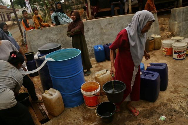 Low on water: Residents collect clean water provided by the local administration on Oct. 13, 2023 in the drought-hit village of Gunungguruh in Sukabumi regency, West Java. The prolonged dry season has dried up wells in the village.