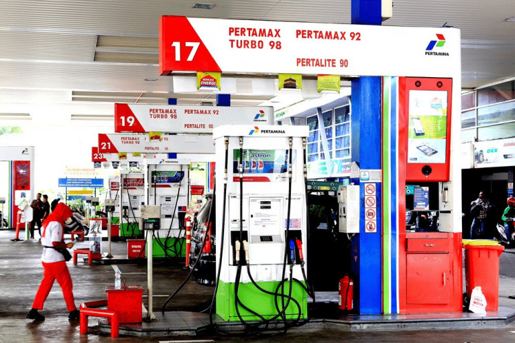 An attendant walks across a gas station belonging to state-owned energy company Pertamina in Kuningan, South Jakarta, in October 2023.