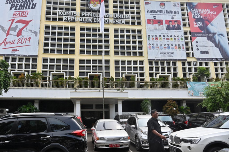 A man walks past the offices of the General Elections Commission (KPU) displaying big banners about the upcoming elections, in Jakarta on January 31, 2019. 