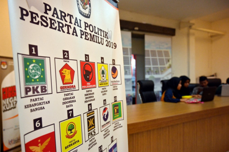 A banner at the offices of the General Elections Commission (KPU) in Jakarta on Jan. 31, 2019, shows many of the political parties campaigning in that year’s election.