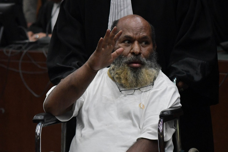 Convicted: Former Papua governor and graft defendant Lukas Enembe waves to his supporters on Oct. 19, 2023, after the verdict hearing at the Jakarta Corruption Court. A panel of judges sentenced him to eight years in prison after finding him guilty of bribery and accepting gratuities pertaining to infrastructure projects in Papua.