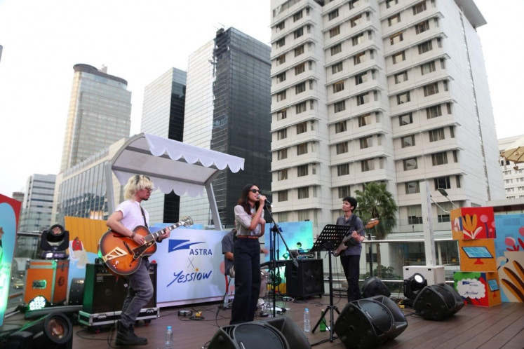 A band performs at the mini concert organized by Astra for commuters on a Transjakarta bus stop platform, in tandem with the launch of the new art installations.