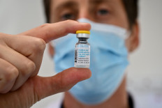 A doctor poses with a monkeypox vaccine vial at a Centre gratuit d'information, de dépistage et de diagnostic (CeGIDD) in Montpellier, southern France on Aug. 23, 2022.