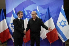 Israeli Prime Minister Benjamin Netanyahu (right) greets French President Emmanuel Macron before a meeting in Jerusalem on October 24, 2023. 