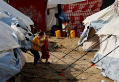 Uprooted: Displaced Palestinian children, who fled their houses amid Israeli strikes, take shelter in a tent camp at a United Nations-run center in Khan Younis in the southern Gaza Strip on Oct. 24, 2023, after Israel's call for more than 1 million civilians in northern Gaza to move south.