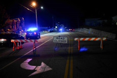 Police surround family home of 'armed and dangerous' US shooting suspect