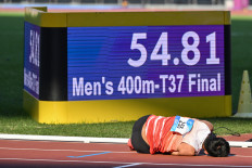 Indonesia's Saptoyogo Purnomo lies on the track after winning the men's 400m-T37 final at the Huanglong Sports Center Stadium during the 2022 Asian Para Games in Hangzhou, China, on Oct. 23, 2023. Saptoyogo won Indonesia’s first gold medal in Hangzhou.