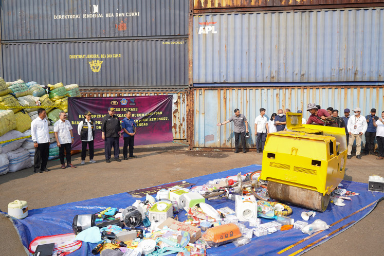 Trade Minister Zulkifli Hasan (second left), Finance Minister Sri Mulyani Indrawati (third left) and Coordinating Economic Minister Airlangga Hartarto (fourth left) watch the destruction of goods allegedly imported illegally in an event staged at a Customs and Excise Office facility in Cikarang, West Java, on Oct. 26, 2023.