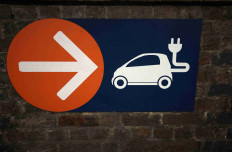 A sign directing towards electric vehicle charging points is seen in a car park in Manchester, Britain, September 8, 2023.