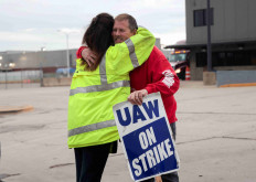 Striking United Auto Workers union members embrace at the end of their picket shift outside the Ford Michigan Assembly Plant in Wayne, Michigan, US, October 25, 2023.