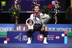 First title: Indonesian men' single shuttler Jonatan Christie poses with his trophy after winning the Super 750 series French Open badminton tournament in Rennes, France, on Sunday. Jonatan defeated Li Shi Feng of China in a rubber-game 16-21, 21-15, 21-14.  
