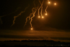 This picture taken from a position near Sderot along the Israeli border with the Gaza Strip on October 31, 2023, shows flares dropped by Israeli forces above the Palestinian enclave amid ongoing battles between Israel and the Palestinian Hamas movement.