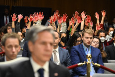 Protesters raise their painted hands as US Secretary of State Antony Blinken and Defense Secretary Lloyd Austin testify during a Senate Appropriations Committee hearing to examine the national security supplemental request, on Capitol Hill in Washington, DC, on October 31, 2023. Blinken and Austin are testifying for a $105 billion request to support Israel, Ukraine and other security priorities.
