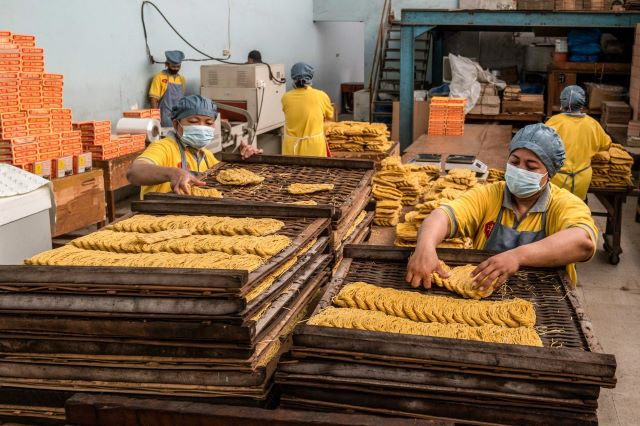 Oodles of growth: Workers produce noodles on Jan. 14, 2023, at a factory in Surabaya, East Java. Indonesia must double its average manufacturing growth of 4.5 percent to become a high-income country.
