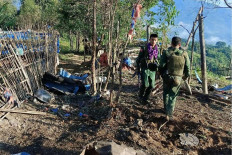This handout photo taken and released on Oct. 28, 2023 by the Kokang Information Network shows members of the Myanmar National Democratic Alliance Army (MNDAA) walking past a Myanmar military base after seizing it during clashes near Laukkaing township in Myanmar's northern Shan state.