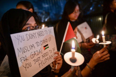 Youths attend a candlelight vigil at the Palestinian embassy in Jakarta on Nov. 2, 2023. Thousands of civilians, both Palestinians and Israelis, have died since Oct. 7, 2023, after Palestinian Hamas militants based in the Gaza Strip entered southern Israel in an unprecedented attack triggering a war declared by Israel on Hamas with retaliatory bombings on Gaza.
