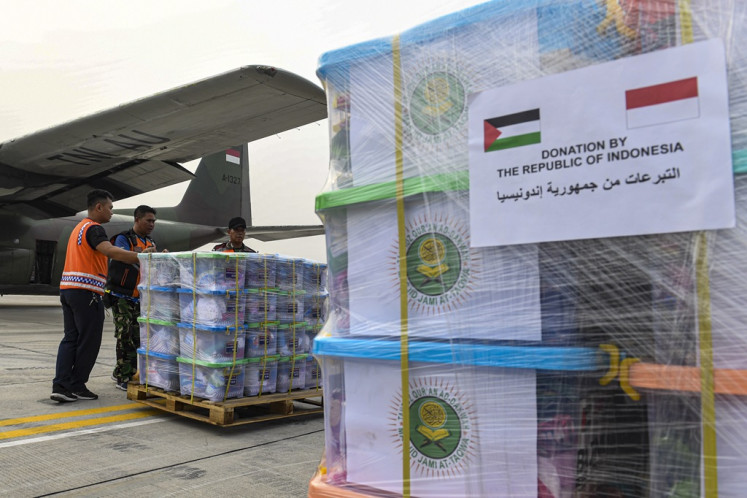 Indonesian Air Force personnel check packages of humanitarian aid on Nov. 4, 2023, which will be sent to Palestine, at the Halim Perdanakusuma airbase in Jakarta. The Indonesian government dispatched 51.5 tonnes of humanitarian aid for people in the war-torn Gaza Strip.