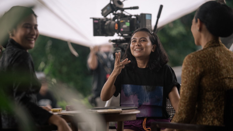 Citra winner Kamila Andini (center) is seen directing Netflix series Gadis Kretek in this undated behind-the-scenes photo file. Courtesy of Netflix