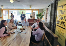 US Federal Reserve Chairman Jerome Powell (center, seated) and the President and CEO of the Philadelphia Federal Reserve Patrick Harker (second right), meet local small business leaders during a visit to York, Pennsylvania, on Oct. 2, 2023.