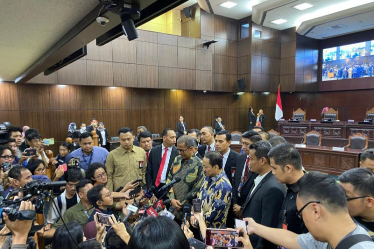 Constitutional Court chief justice-elect Suhartoyo (center right) and Deputy Chief Justice Saldi Isra (center left) speak to the press at the court building in Central Jakarta, on Nov. 9, 2023.