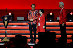 Megawati Soekarnoputri (center), chairwoman of the Indonesia Democratic Party of Struggle (PDI-P), and President Joko “Jokowi“ Widodo (left) share a moment on Sept. 29, 2023, as PDI-P presumptive presidential candidate Ganjar Pranowo looks on, during the party's national meeting in Jakarta.(