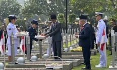 President Joko “Jokowi' Widodo (center) scatters flower petals while Vice President Ma’ruf Amin (second right) looks on during a Heroes Day ceremony at the Kalibata National Heroes Cemetery in South Jakarta on Nov. 10, 2023. Jokowi declared on Friday six provincial figures as national heroes to commemorate Heroes Day.   