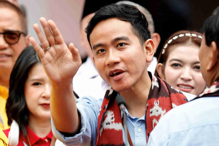 Vice presidential candidate Gibran Rakabuming Raka, who is the eldest son of President Joko “Jokowi” Widodo and the mayor of Surakarta, waves after registering for the 2024 presidential election alongside presidential candidate Prabowo Subianto in Jakarta on Oct. 25, 2023.