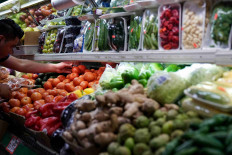 A person arranges groceries in El Progreso Market in the Mount Pleasant neighborhood of Washington, D.C., US, August 19, 2022.