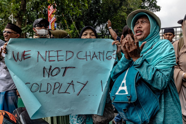 Protesters demand the cancellation of a concert by British rock band Coldplay, which the protesters say supports LGBTQ rights in violation of Muslim doctrine, near the Gelora Bung Karno stadium where the band was scheduled to perform on the same day, in Jakarta on Nov. 15, 2023.
